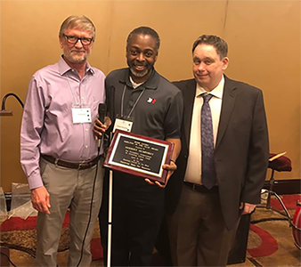 Eddie Turner and Roy Granger presenting Herbert Humphrey with the 2018 
        Jessie Jaynes Employee of the Year Award.