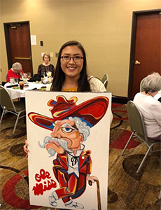 Member and volunteer Haley Shue walking around with hand-painted Ole Miss Rebel at the 2018 MCB Convention Auction